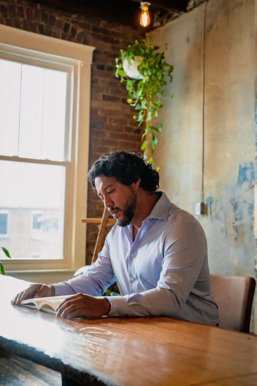 Professional working at a table inside NEXUS Spaces